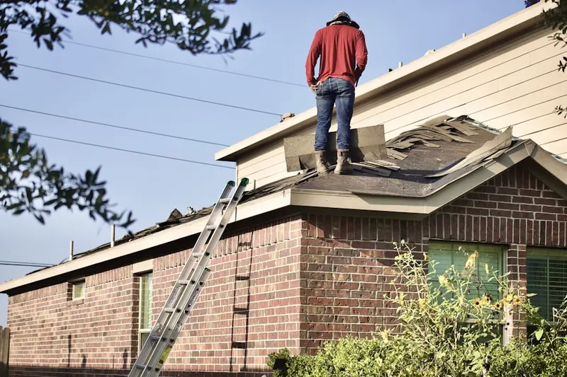 Professional roofer working on a residential roof in Quail Valley